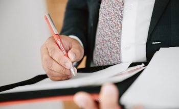 Franchisee writing notes for a business plan